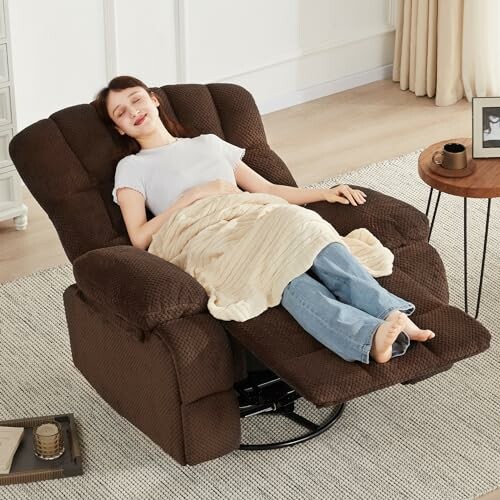 Woman relaxing in a brown recliner chair with a blanket.